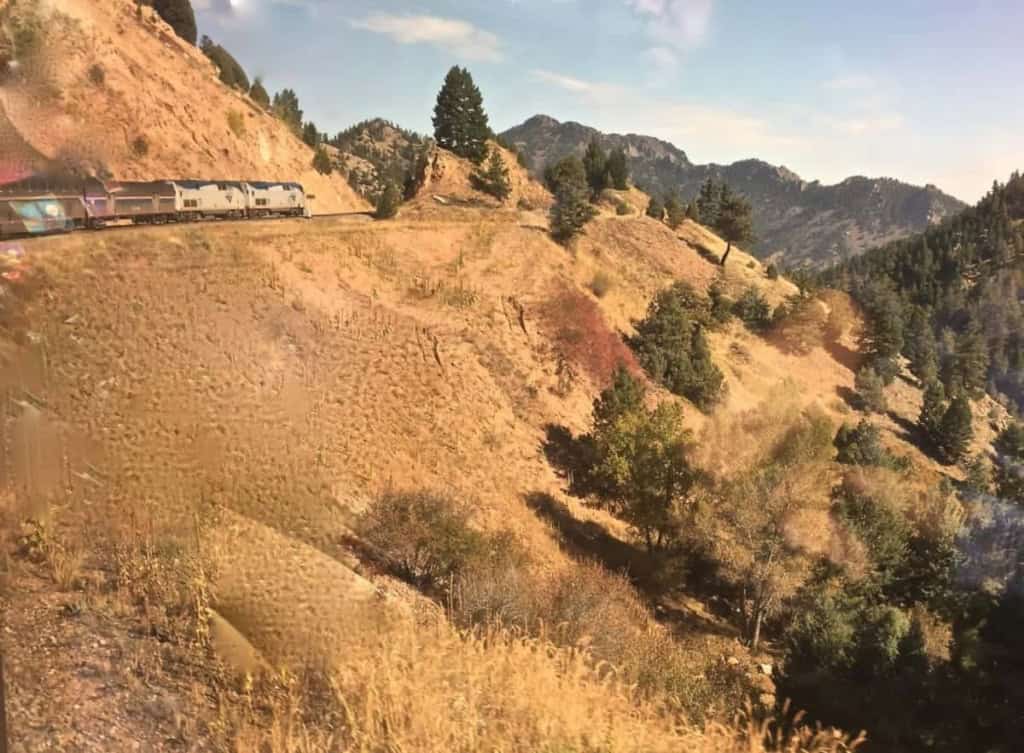 View of Amtrak Zephyr engine and cars along a mountain switchback in Utah.