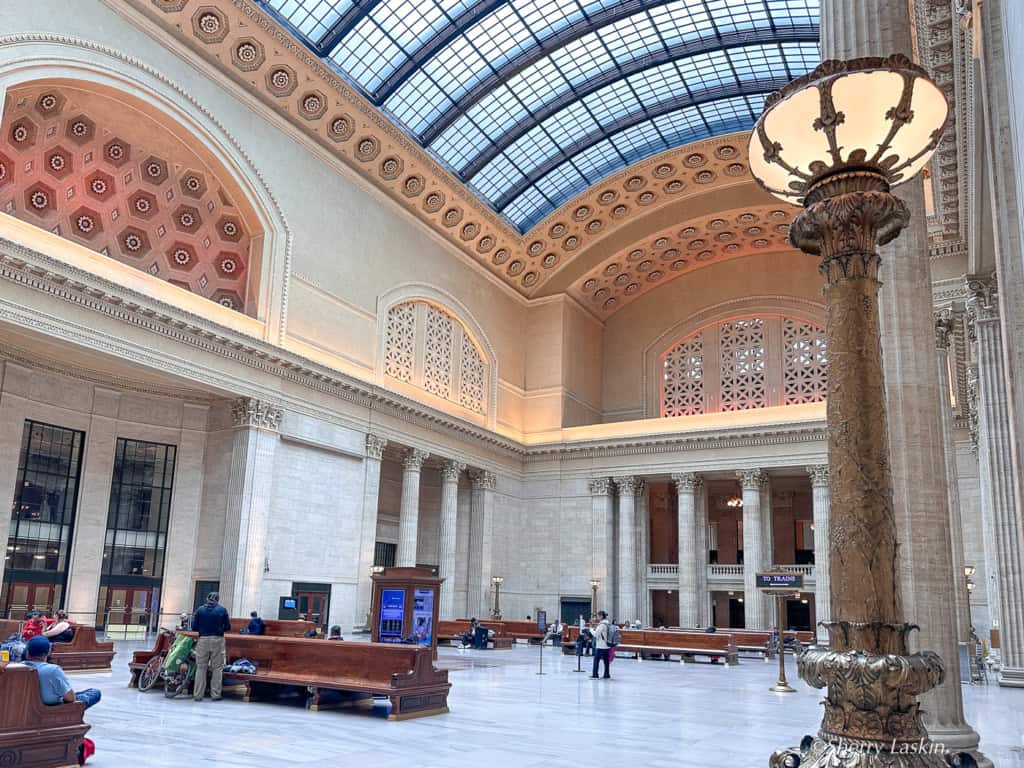 Inside Chicago Union Station in the Great Hall with pillars and benches.