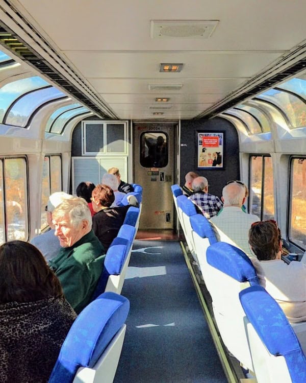 People sitting in Amtrak Observation Car.