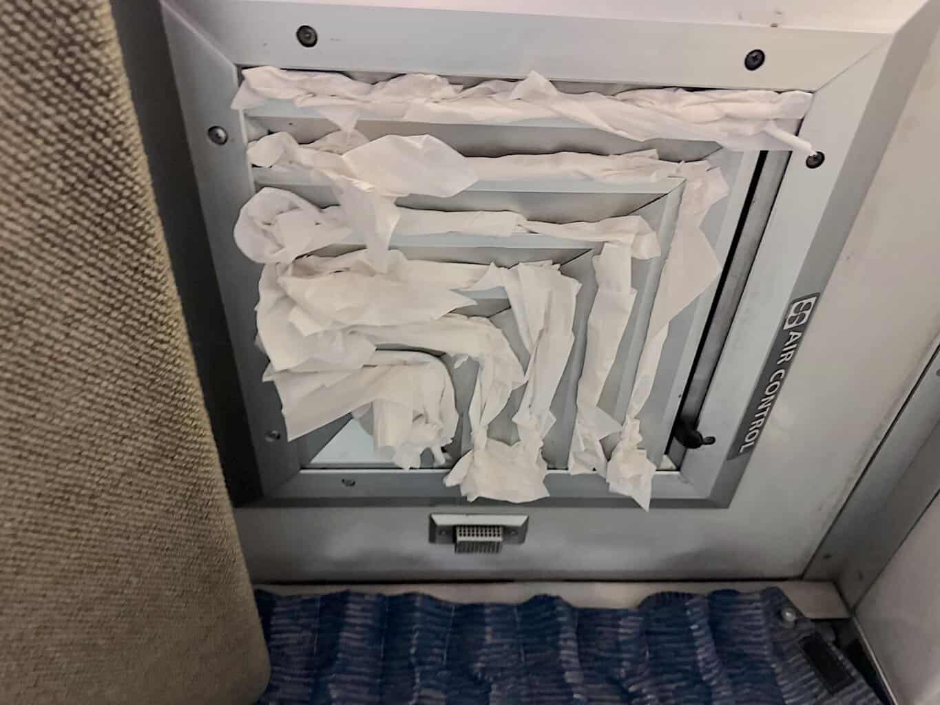 Amtrak bedroom with air conditioning vent stuffed with tissue.
