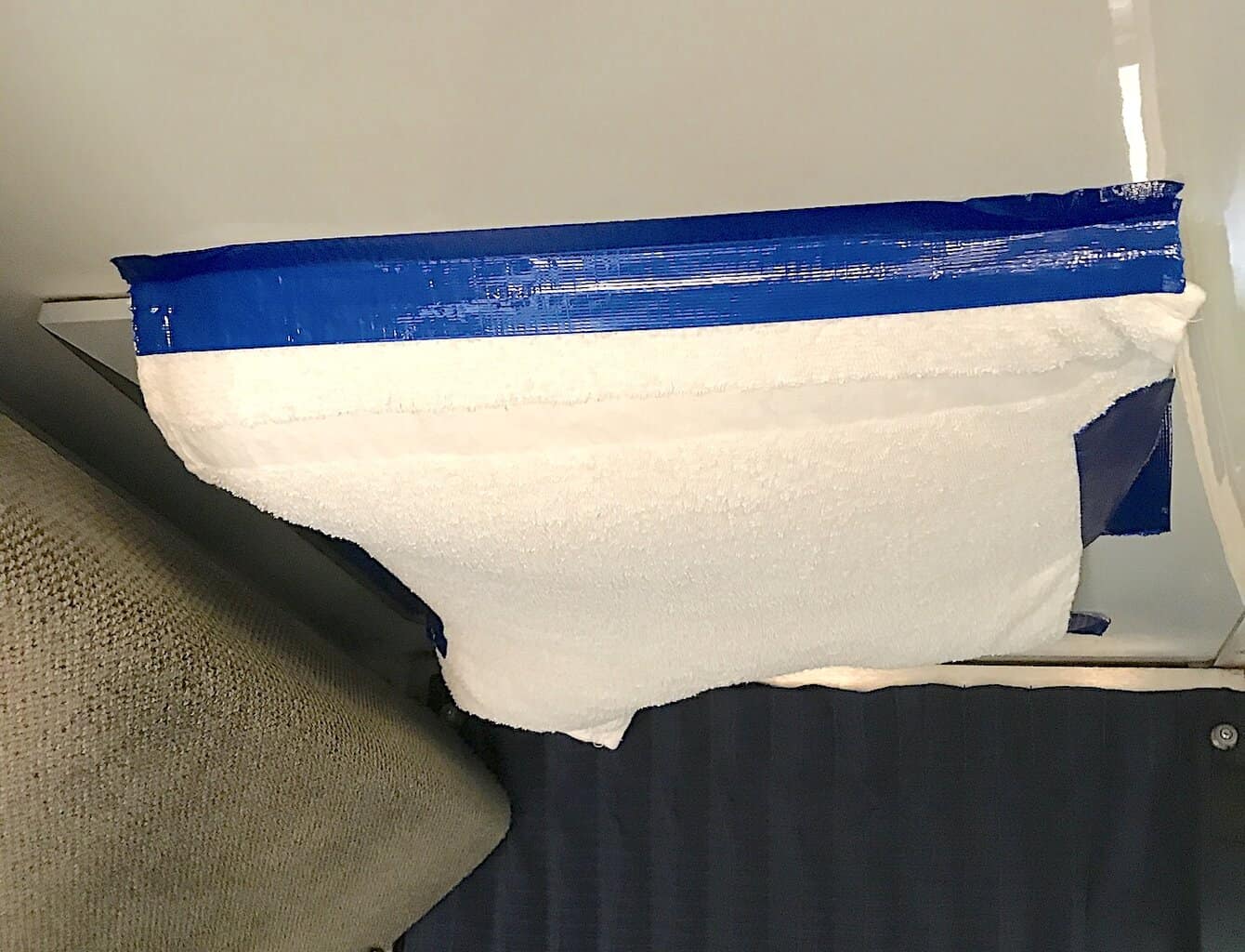 amtrak air conditioning vent with towel covering the vents, held in place with blue duct tape.