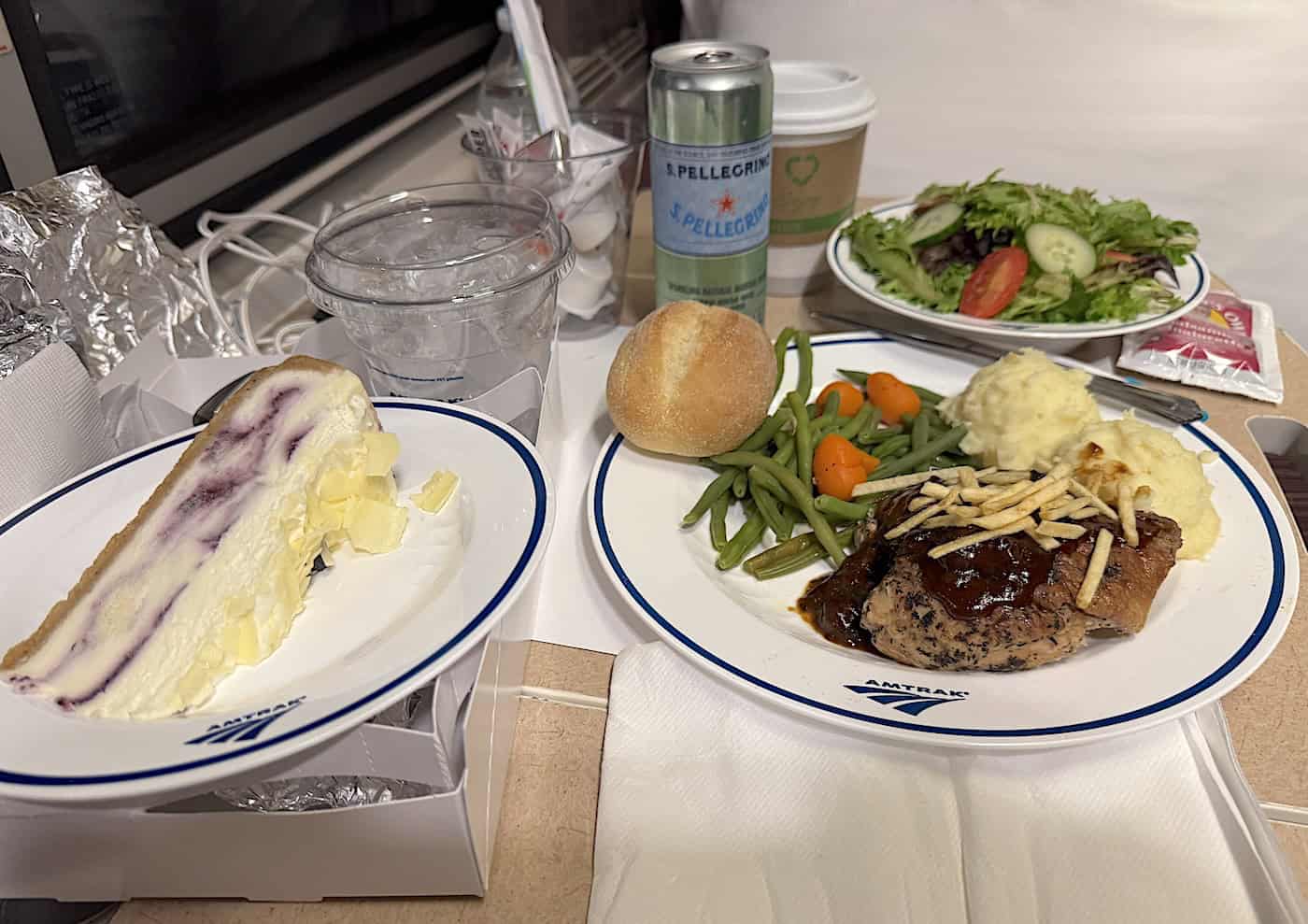 Dinner served in roomette; roast chicken, veggies, cheesecake.
