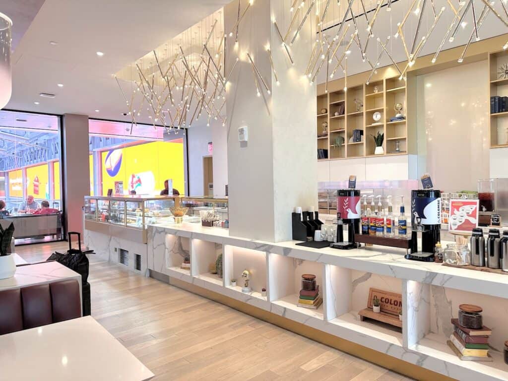 Amtrak's Metropolitan Lounge complimentary food counter with coffee, sandwiches and assorted beverages.