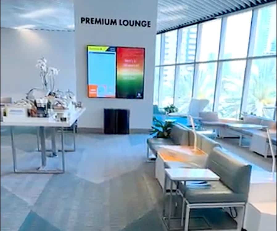 Premium Class lounge with departure board plus the buffet table with complimentary food.