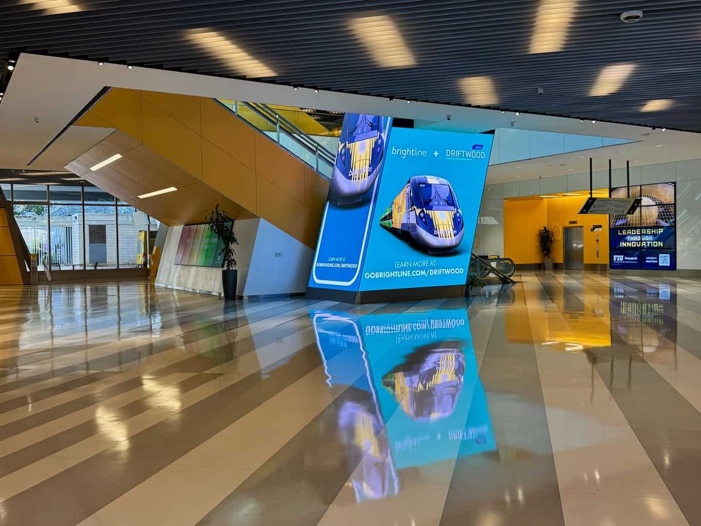 Miami Brightline station first floor with electronic advertising signs.